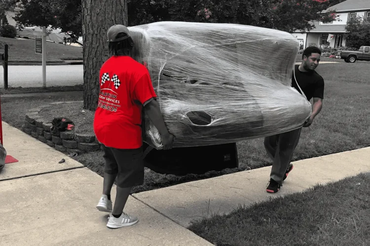 Marathon Moving Service crew in action carrying a couch